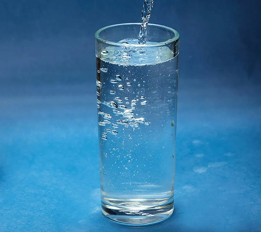 Glass being filled with clear drinking water